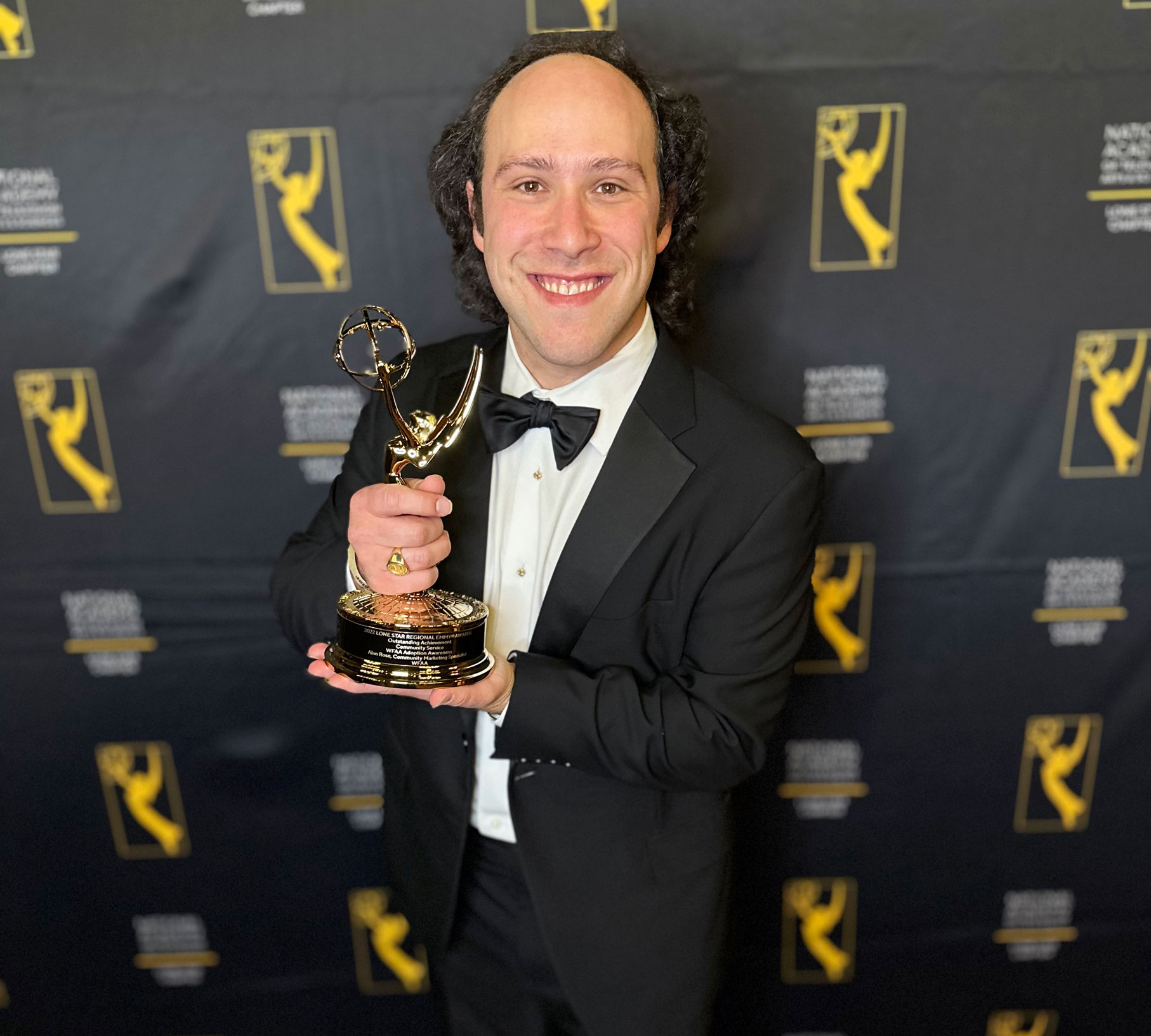 Journalism and film alum Alan Rose (B.A. '10) holds his 2022 Lone Star Regional EMMY for his work at WFAA.